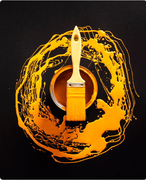 Paintbrush with yellow paint splash